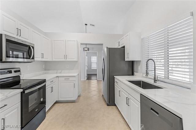 kitchen with stainless steel appliances, sink, and white cabinets