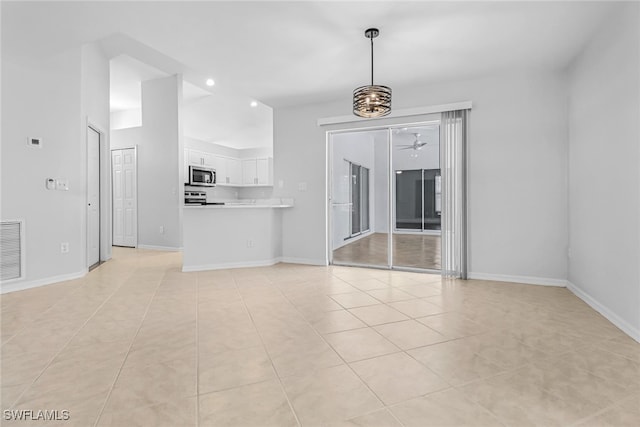 unfurnished living room with ceiling fan and light tile patterned flooring