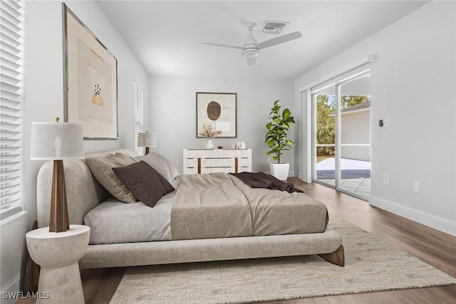 bedroom with access to exterior, wood-type flooring, and ceiling fan