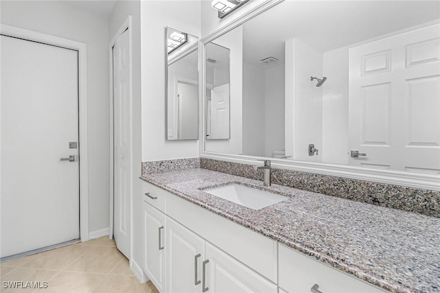 bathroom with vanity, tile patterned floors, and a shower