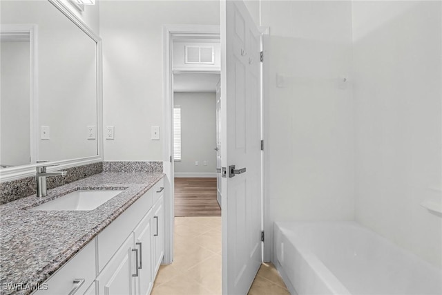 bathroom featuring tile patterned flooring and vanity