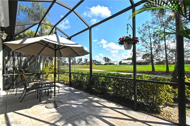 view of patio with glass enclosure