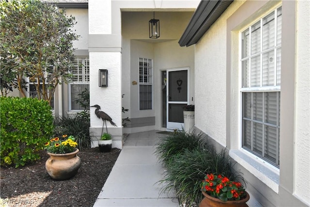 property entrance with stucco siding