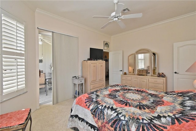 carpeted bedroom featuring crown molding, a ceiling fan, and visible vents