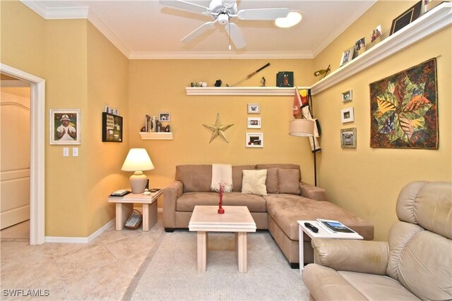 living area with light tile patterned floors, a ceiling fan, ornamental molding, and baseboards