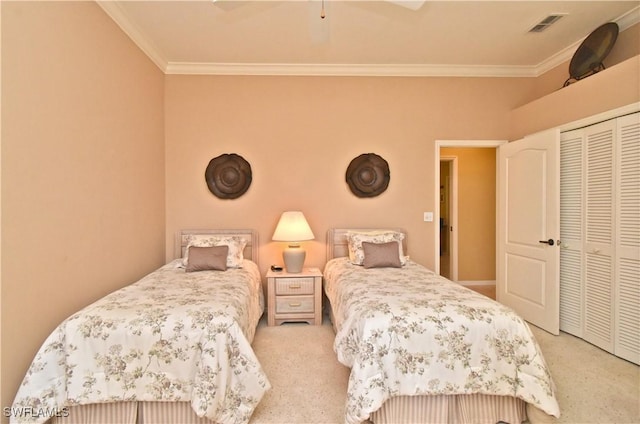 carpeted bedroom with crown molding, a closet, and ceiling fan