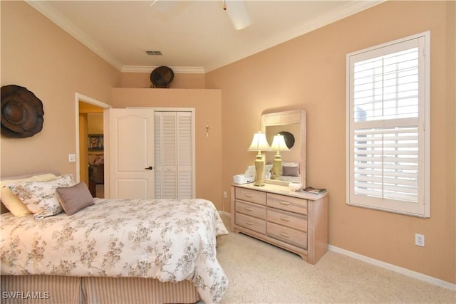 carpeted bedroom featuring ornamental molding, ceiling fan, and a closet