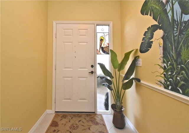 tiled foyer entrance with baseboards