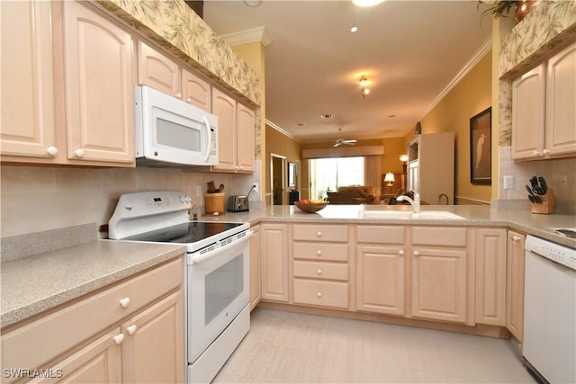 kitchen with white appliances, crown molding, baseboards, light countertops, and wallpapered walls