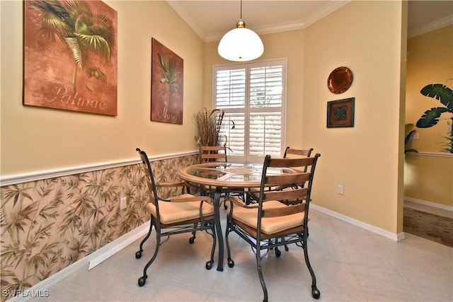 dining space featuring crown molding