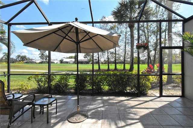 view of patio with outdoor dining space, a lanai, and a ceiling fan