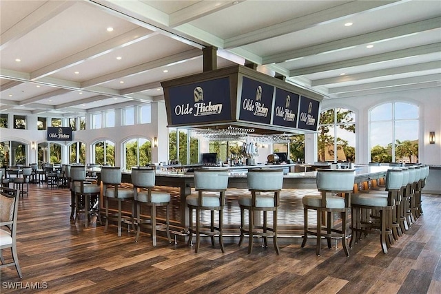 bar with recessed lighting, beamed ceiling, wood finished floors, and a community bar