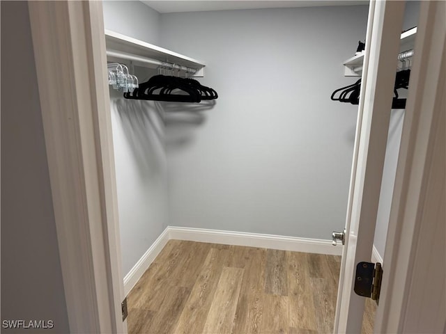 walk in closet featuring light hardwood / wood-style floors