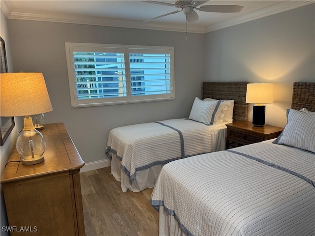 bedroom with hardwood / wood-style flooring, ornamental molding, and ceiling fan