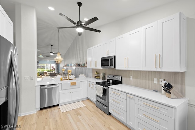 kitchen with white cabinetry, light hardwood / wood-style floors, ceiling fan, and appliances with stainless steel finishes