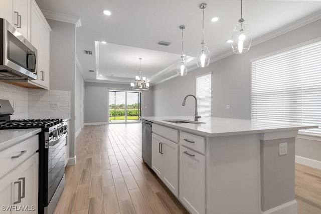 26930 Lark Ct, Punta Gorda, FL 33955 - kitchen with appliances with stainless steel finishes, a sink, a chandelier, ornamental molding, and recessed lighting