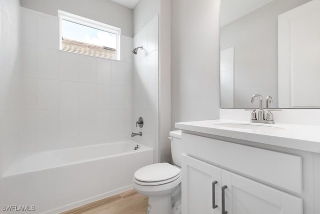 26930 Lark Ct, Punta Gorda, FL 33955 - bathroom with toilet, vanity, wood finished floors, and tub / shower combination