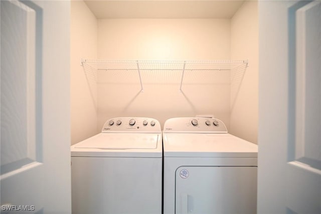 clothes washing area featuring washer and dryer