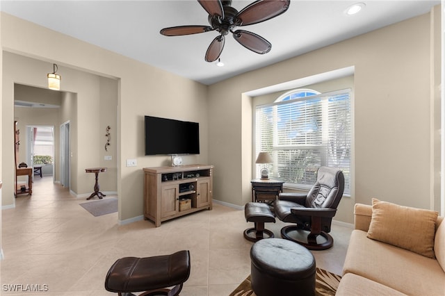 living room featuring light tile patterned flooring, plenty of natural light, and ceiling fan