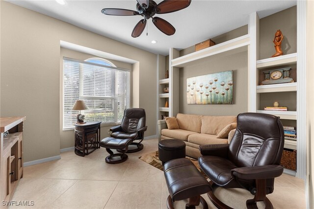 living area with ceiling fan, built in features, and light tile patterned floors