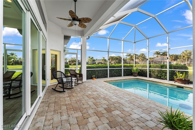 view of pool featuring a lanai, ceiling fan, and a patio area