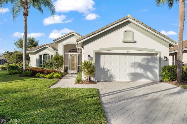 view of front of property with a garage and a front lawn