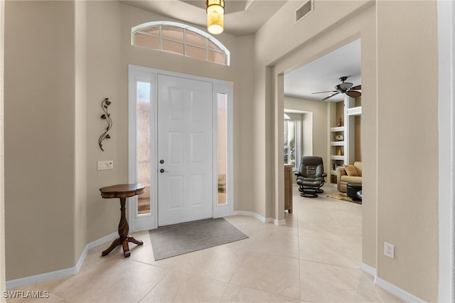 entryway featuring ceiling fan and light tile patterned floors