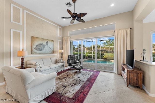 living room featuring light tile patterned floors and ceiling fan