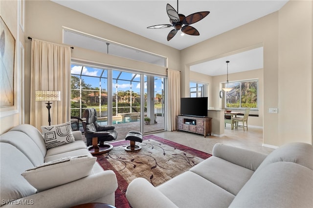 tiled living room featuring plenty of natural light and ceiling fan