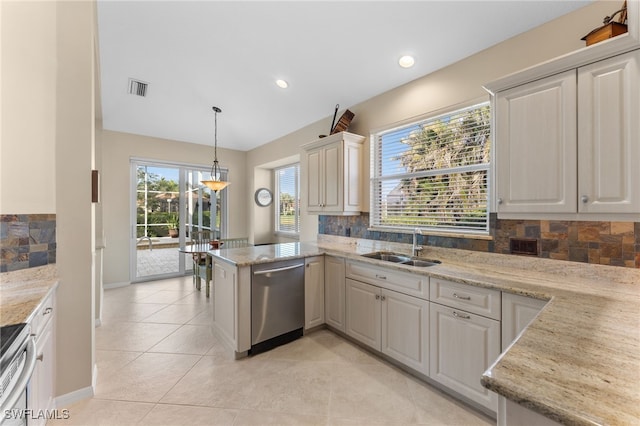 kitchen featuring appliances with stainless steel finishes, pendant lighting, sink, light tile patterned floors, and kitchen peninsula