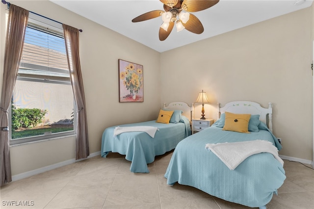 bedroom with ceiling fan and light tile patterned floors