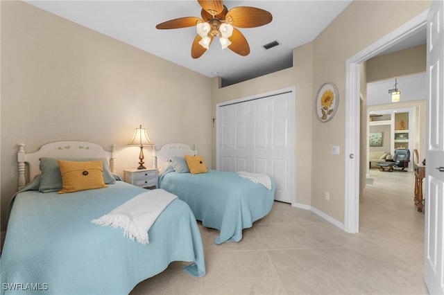 tiled bedroom with a closet and ceiling fan