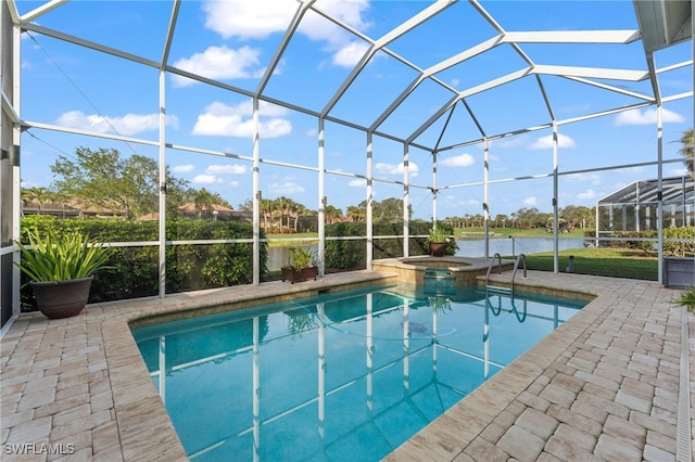 view of pool featuring a patio area, an in ground hot tub, a water view, and glass enclosure