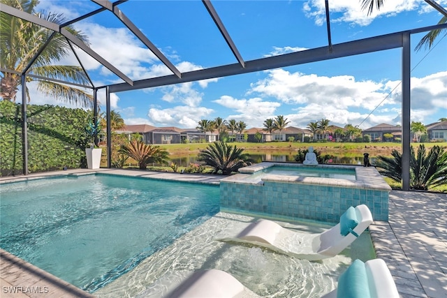 view of pool with a lanai, a patio area, and an in ground hot tub