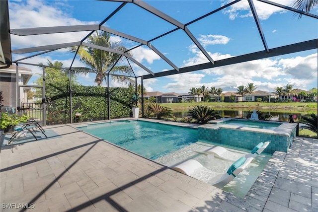 view of pool with a water view, an in ground hot tub, a patio area, and glass enclosure