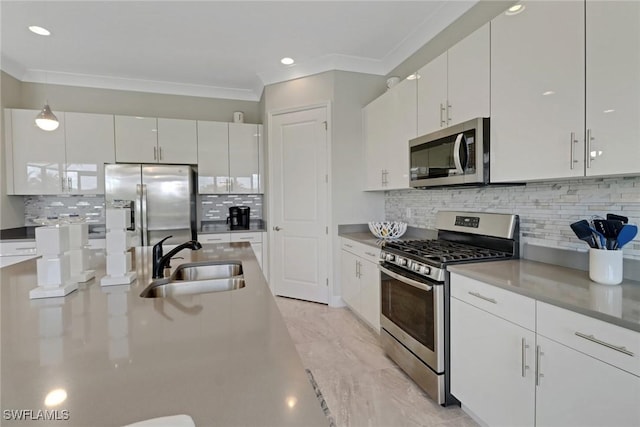 kitchen featuring white cabinetry, ornamental molding, stainless steel appliances, and sink