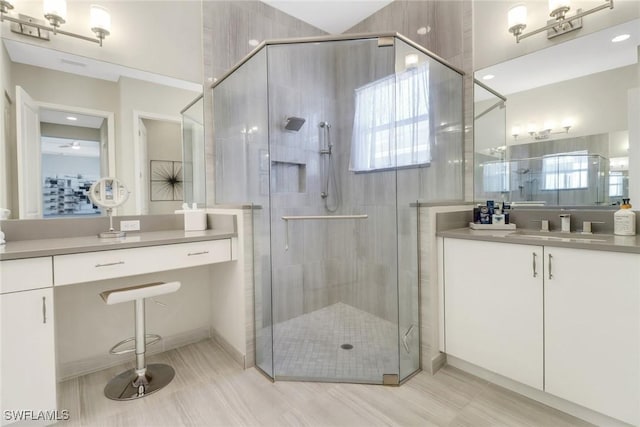 bathroom featuring vanity, an enclosed shower, and a healthy amount of sunlight