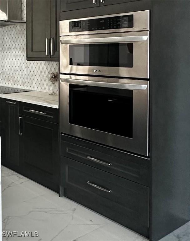 kitchen featuring tasteful backsplash, stainless steel double oven, and black electric cooktop