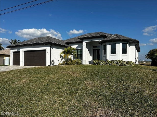 view of front of home with a garage and a front yard