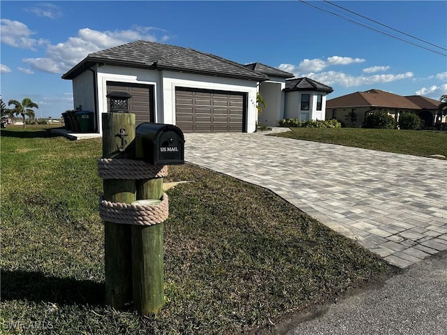 single story home featuring a garage and a front yard