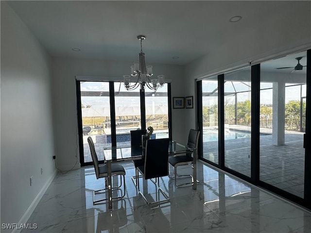 dining room featuring a healthy amount of sunlight and ceiling fan with notable chandelier