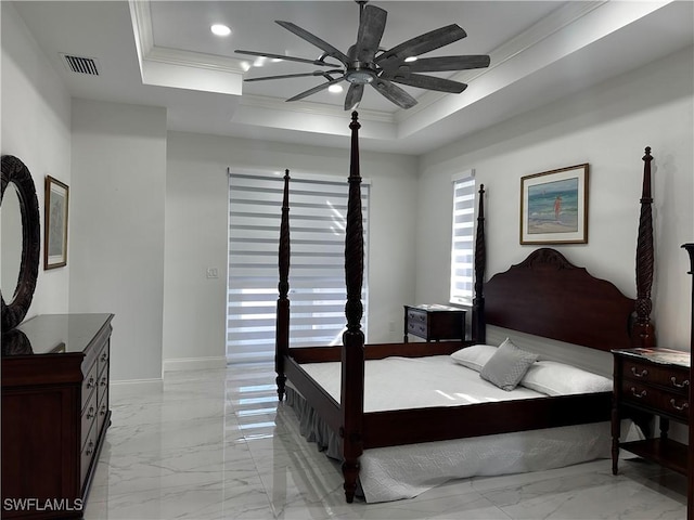 bedroom with crown molding, ceiling fan, and a tray ceiling