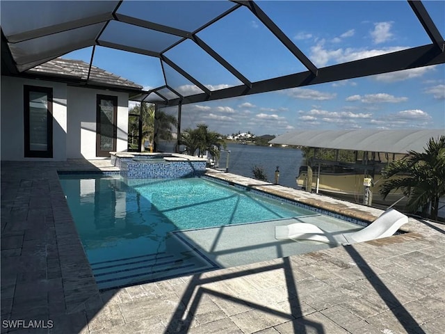 view of pool featuring an in ground hot tub, a water view, a patio area, and a lanai