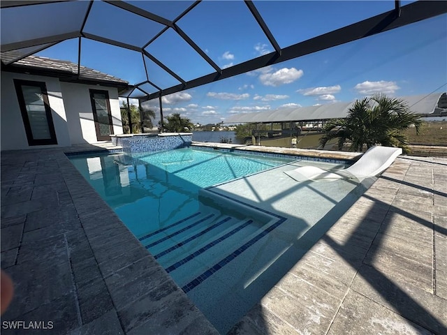 view of swimming pool featuring an in ground hot tub, glass enclosure, and a patio area