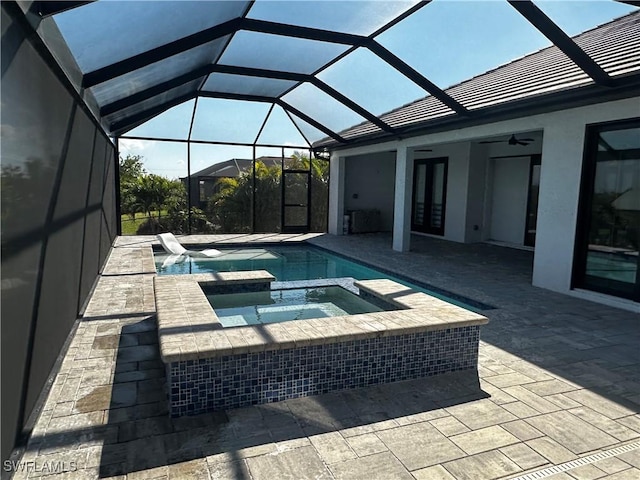 view of pool featuring french doors, a lanai, an in ground hot tub, ceiling fan, and a patio