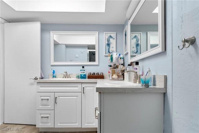 bathroom featuring vanity and hardwood / wood-style floors