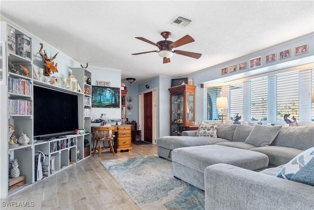 living room with ceiling fan and light wood-type flooring