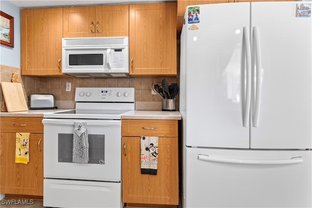 kitchen featuring white appliances and decorative backsplash