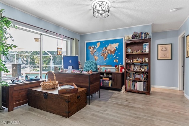 office with crown molding, a chandelier, a textured ceiling, and light wood-type flooring