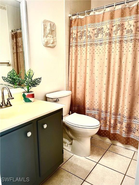 bathroom featuring tile patterned flooring, vanity, and toilet